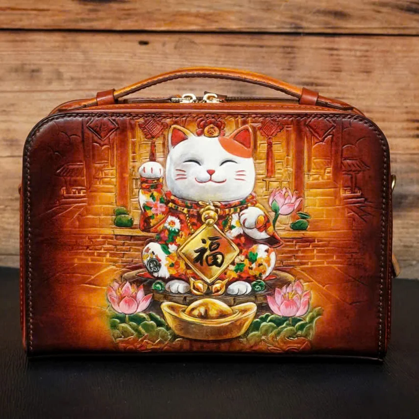 Saigon Leather’s Lucky Maneki Neko Full-Grain Leather Bag with Lotus Detailing