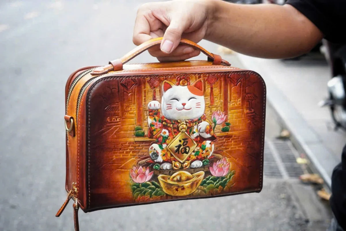 Saigon Leather’s Lucky Maneki Neko Full-Grain Leather Bag with Lotus Detailing - Image 5